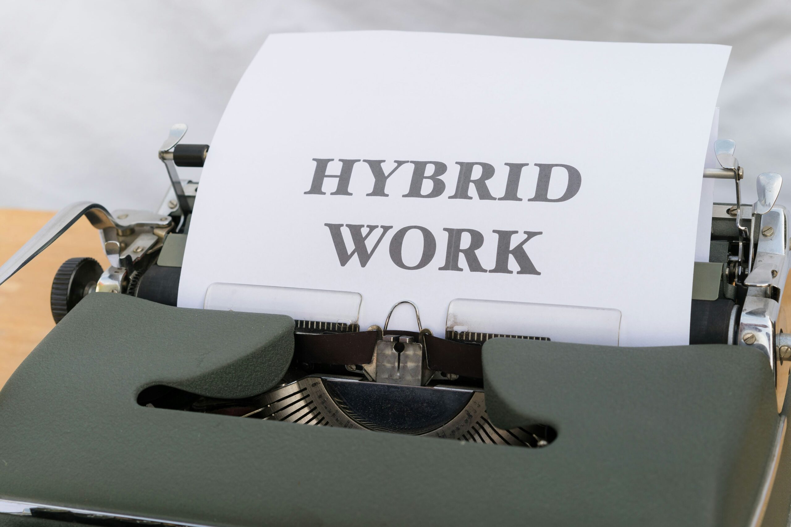 a typewriter with a paper that reads hybrid work
