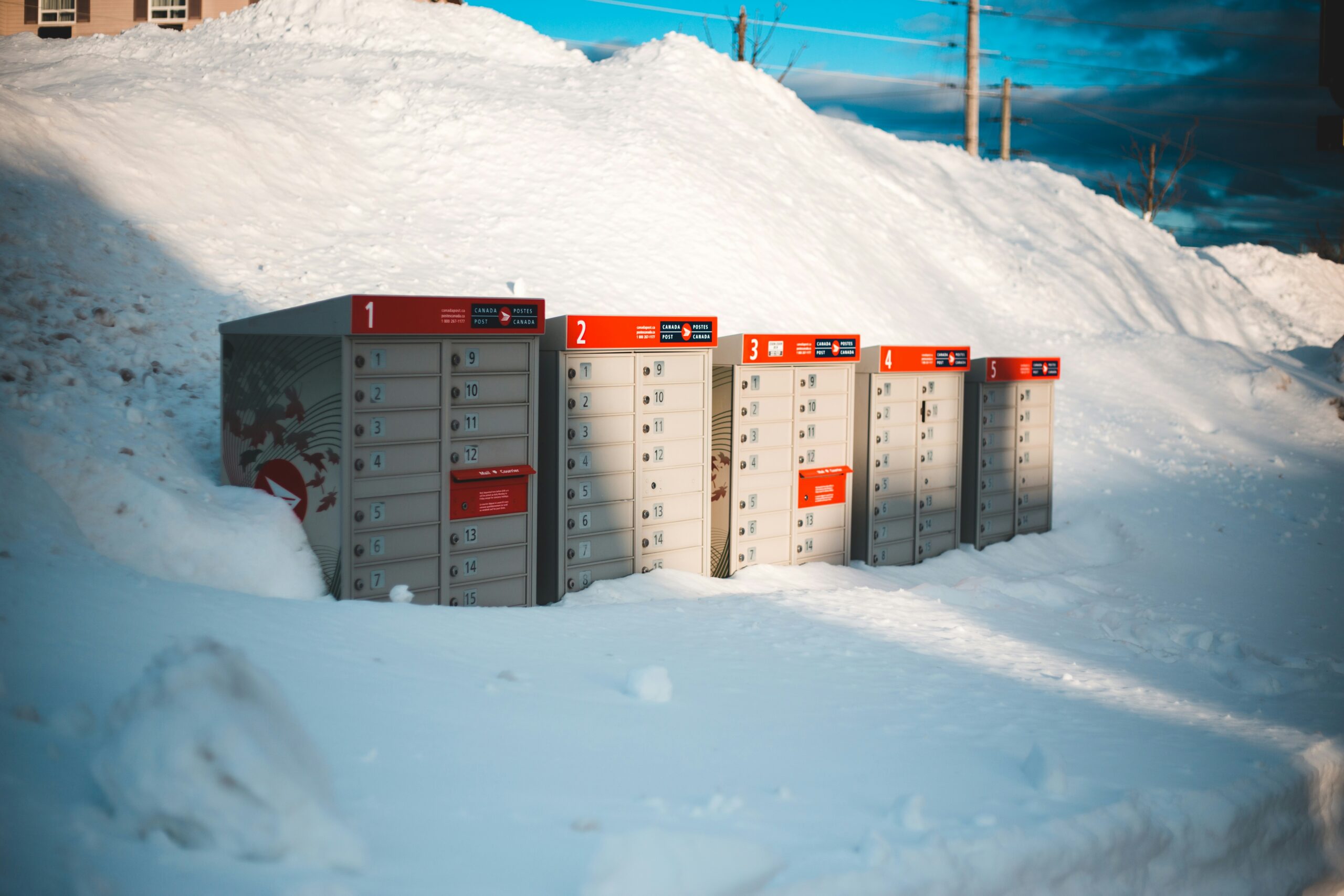 white and red storage boxes on snow covered ground